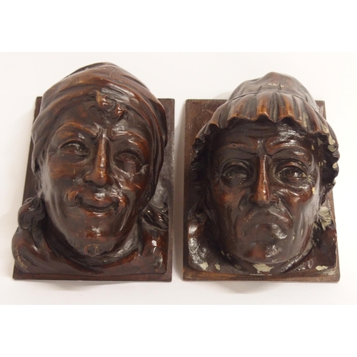 104A - A PAIR OF CARVED HEADS