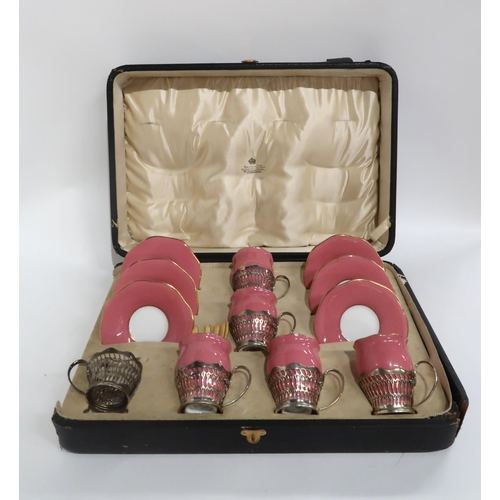 105 - A BOXED SET OF SIX PINK AND GILT COALPORT COFFEE CUPS AND SAUCERS