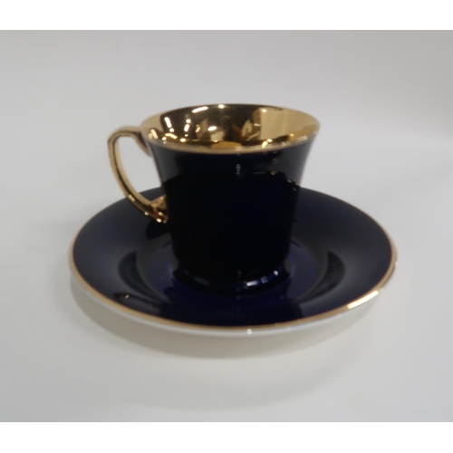 87 - SIX CROWN DEVON DARK BLUE AND GILT COFFEE CUPS AND SAUCERS