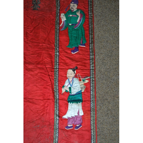 130 - A CHINESE BLACK AND RED SILK BANNER