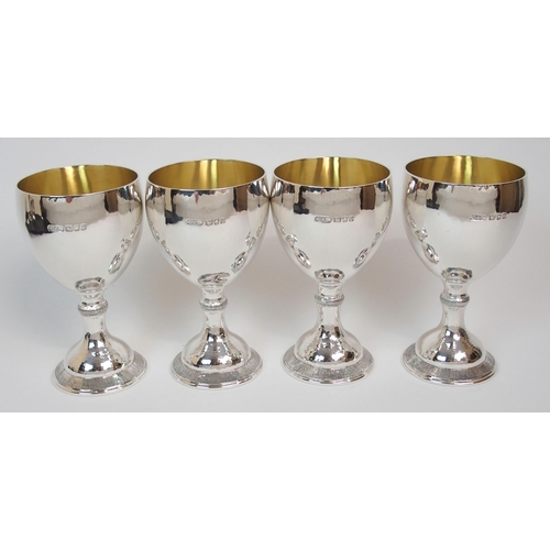 199 - A SET OF FOUR HAMMERED SILVER GOBLETS