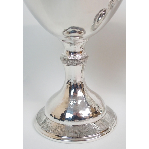 199 - A SET OF FOUR HAMMERED SILVER GOBLETS