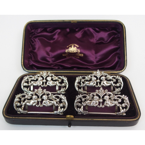 214 - A CASED SET OF FOUR SILVER MENU HOLDERS