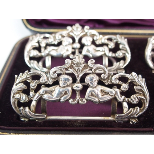 214 - A CASED SET OF FOUR SILVER MENU HOLDERS