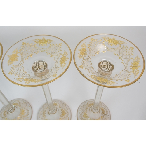 578 - A SET OF FOUR GLASS CANDLE HOLDERS