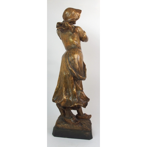 593 - A GOLDSCHEIDER GILDED TERRACOTTA FIGURE OF A FARM GIRL