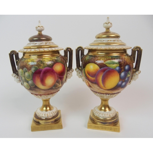 599 - A PAIR OF ROYAL WORCESTER TWO-HANDLED JARS AND COVERS