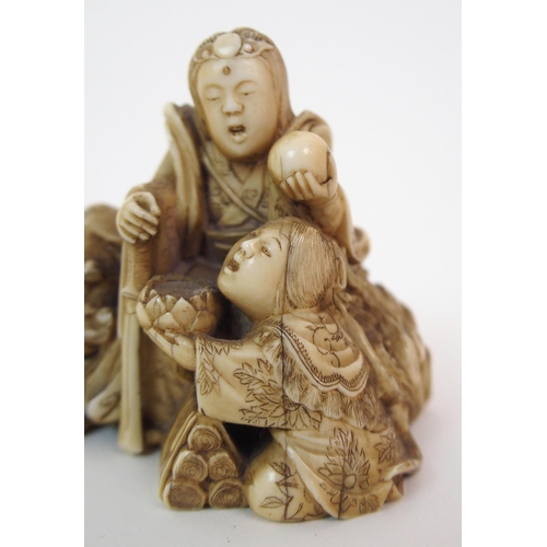 79 - A JAPANESE IVORY NETSUKE OF A LION