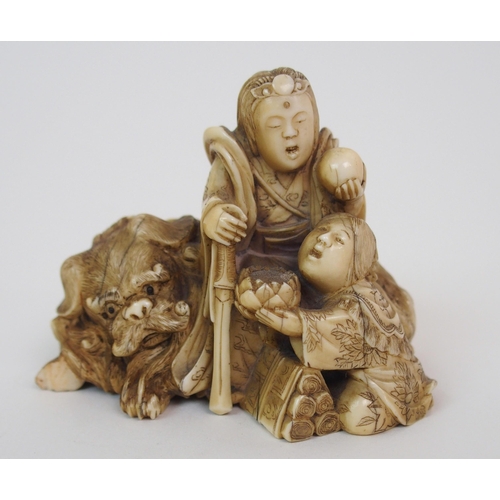 79 - A JAPANESE IVORY NETSUKE OF A LION