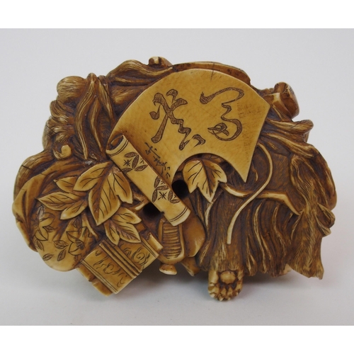 79 - A JAPANESE IVORY NETSUKE OF A LION