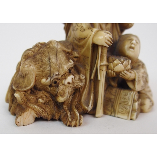 79 - A JAPANESE IVORY NETSUKE OF A LION