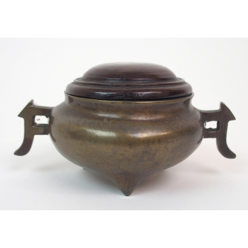 86 - A CHINESE BRONZE TWO-HANDLED CENSER AND HARDWOOD COVER