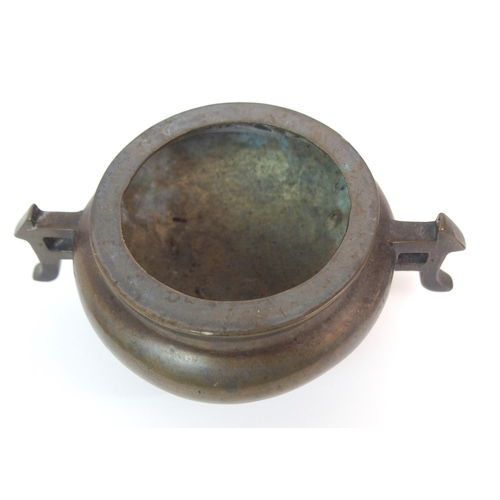 86 - A CHINESE BRONZE TWO-HANDLED CENSER AND HARDWOOD COVER