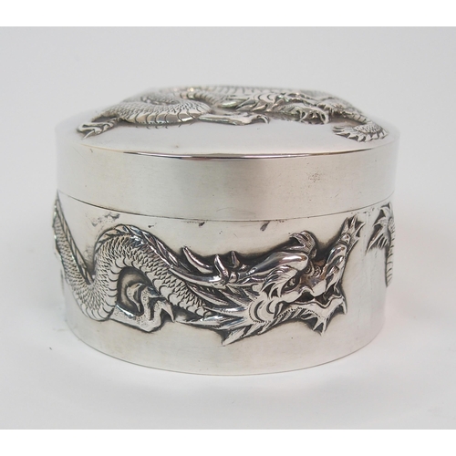 9 - A CHINESE SILVER CIRCULAR EMBOSSED BOX AND COVER