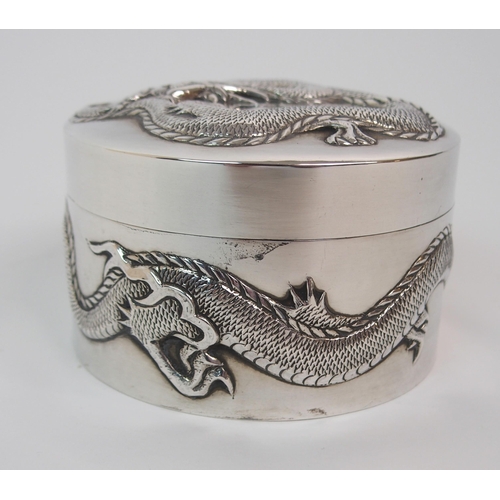 9 - A CHINESE SILVER CIRCULAR EMBOSSED BOX AND COVER