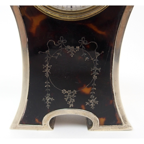 152 - A silver cased and tortoiseshell mounted mantle clock