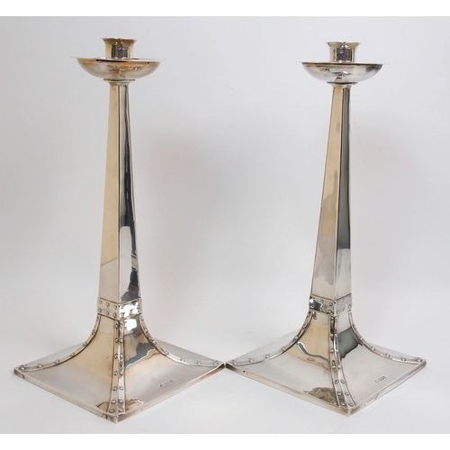 155 - A pair of Arts and Crafts silver candlesticks