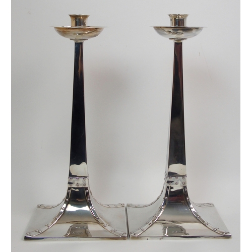 155 - A pair of Arts and Crafts silver candlesticks