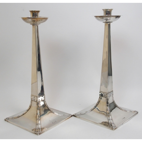 155 - A pair of Arts and Crafts silver candlesticks