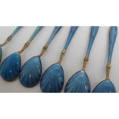 167 - A cased set of six Norwegian silver gilt and blue enamel salt spoons