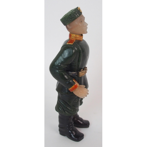 325 - A late 20th Century copy of a Faberge hard stone figure of a Cossack with yellow-metal rifle