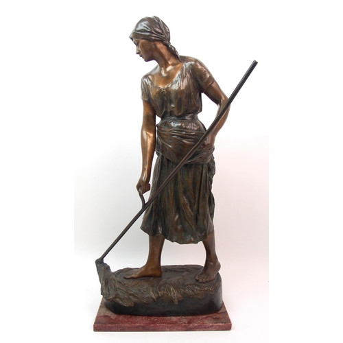 476 - A large Goldscheider patinated bronze of a girl holding a scythe