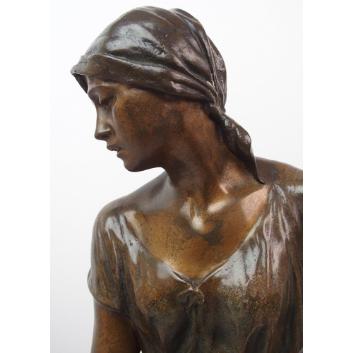 476 - A large Goldscheider patinated bronze of a girl holding a scythe