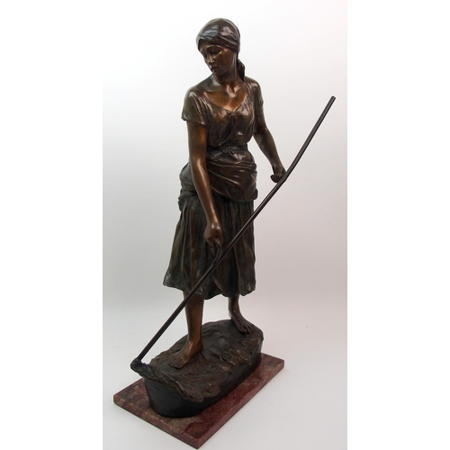 476 - A large Goldscheider patinated bronze of a girl holding a scythe