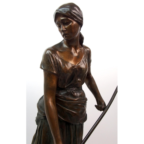 476 - A large Goldscheider patinated bronze of a girl holding a scythe