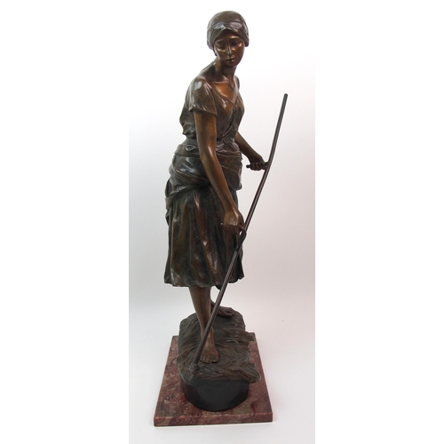 476 - A large Goldscheider patinated bronze of a girl holding a scythe