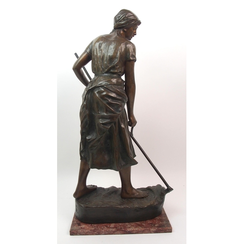 476 - A large Goldscheider patinated bronze of a girl holding a scythe