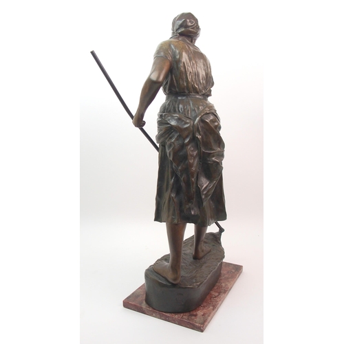 476 - A large Goldscheider patinated bronze of a girl holding a scythe