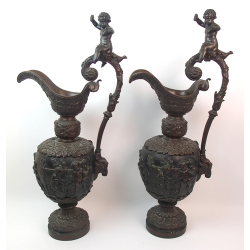 477 - A large pair of bronze ornamental jugs