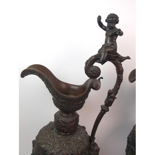 477 - A large pair of bronze ornamental jugs