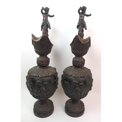 477 - A large pair of bronze ornamental jugs