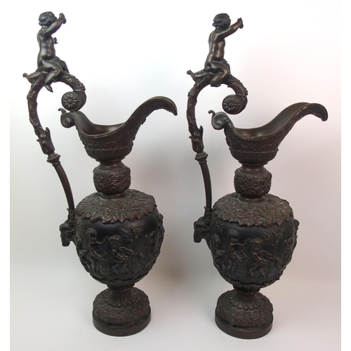 477 - A large pair of bronze ornamental jugs