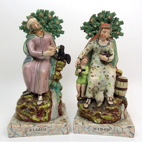 504 - A pair of 19th Century Staffordshire figures of Elijah and the Widow