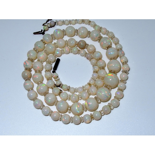 628 - A string of white opal beads