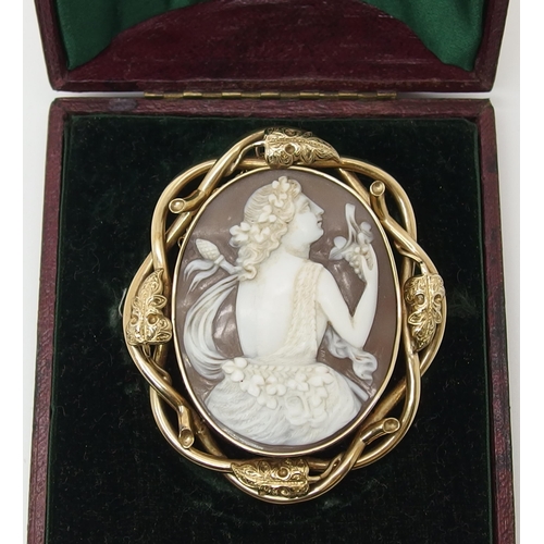 639 - A large shell cameo of a maiden in yellow metal brooch mount