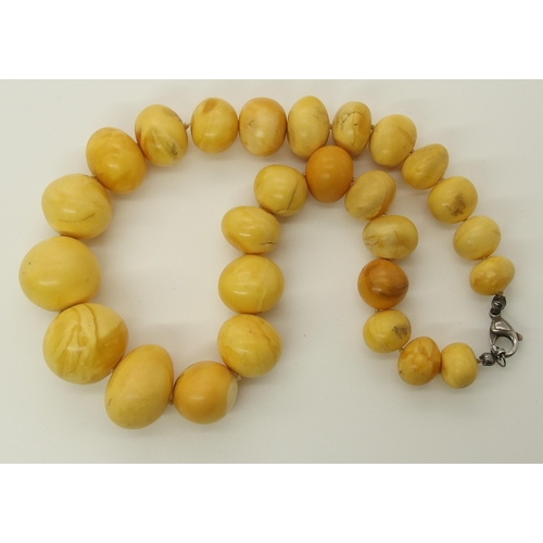 640 - A string of amber coloured beads