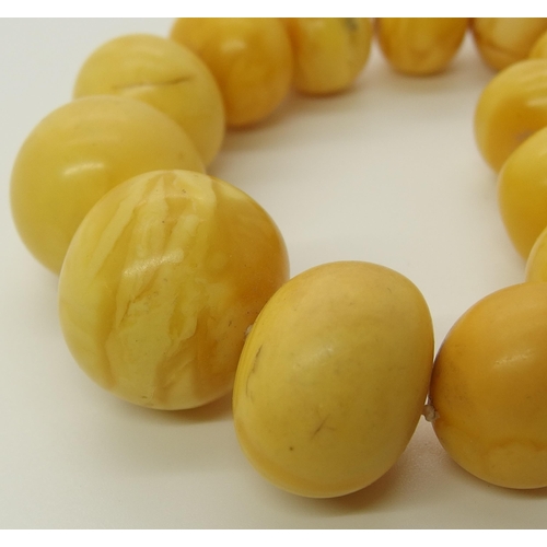 640 - A string of amber coloured beads