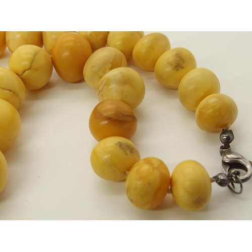 640 - A string of amber coloured beads