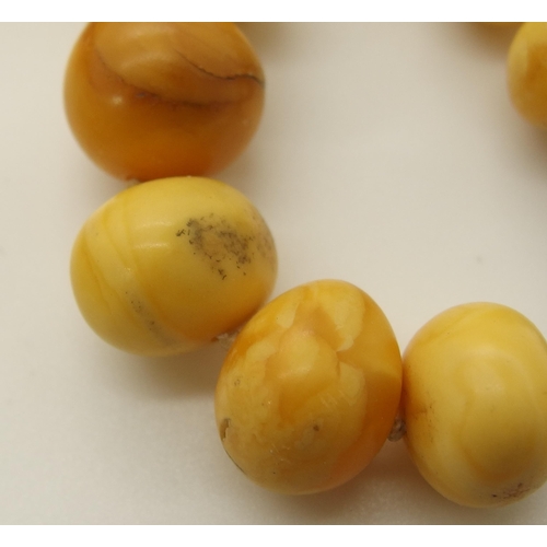 640 - A string of amber coloured beads