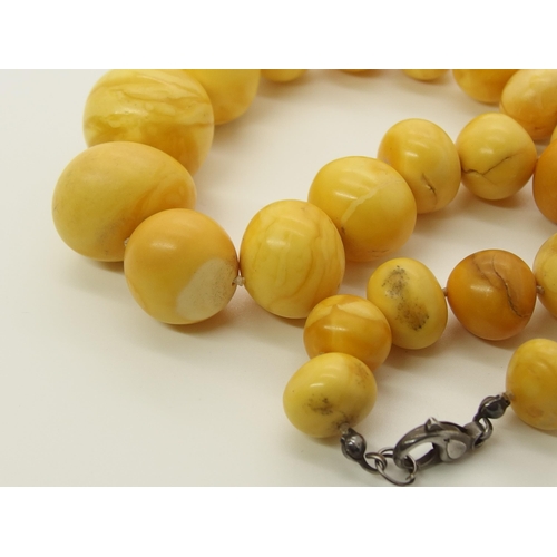 640 - A string of amber coloured beads