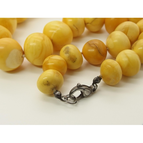 640 - A string of amber coloured beads