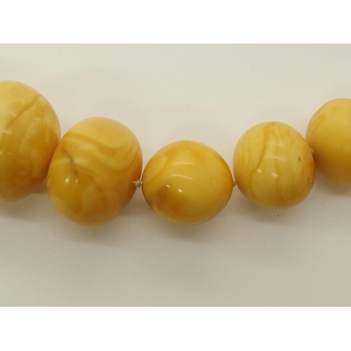 640 - A string of amber coloured beads