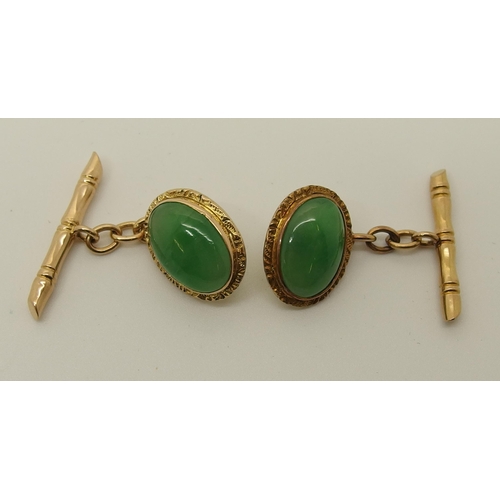 643 - A pair of 18ct Chinese gold  Chinese green hardstone cufflinks