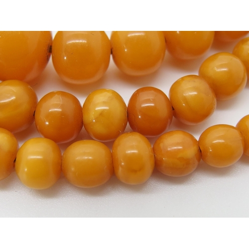 645 - A string of amber coloured beads