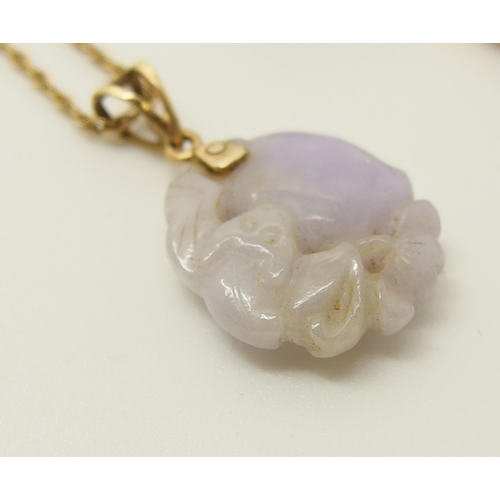 646 - A Chinese lilac coloured hardstone pendant and earrings