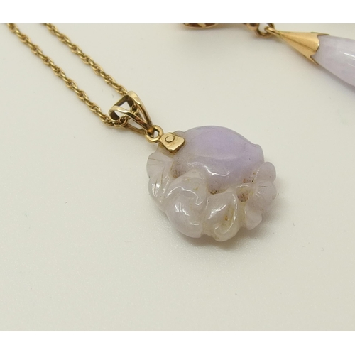 646 - A Chinese lilac coloured hardstone pendant and earrings